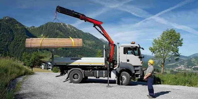 Truck loader crane rental Abu Dhabi — Taineq crane mounted truck on construction site UAE