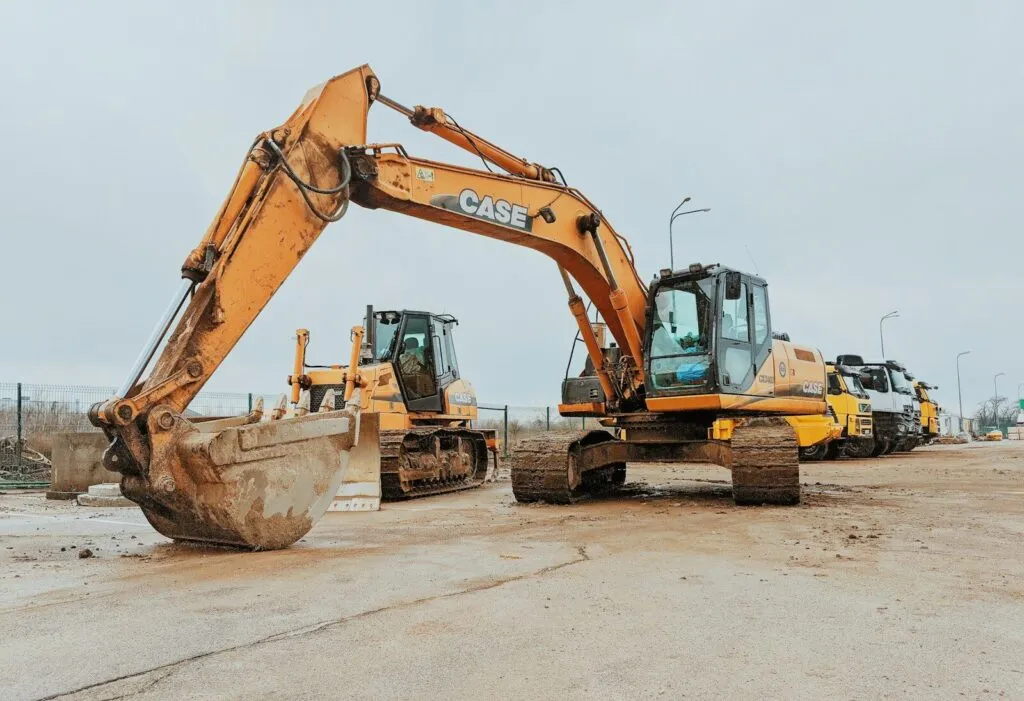 Excavator Rental Abu Dhabi | Chain & Tyre Excavator Hire yellow excavator on gray concrete road during daytime