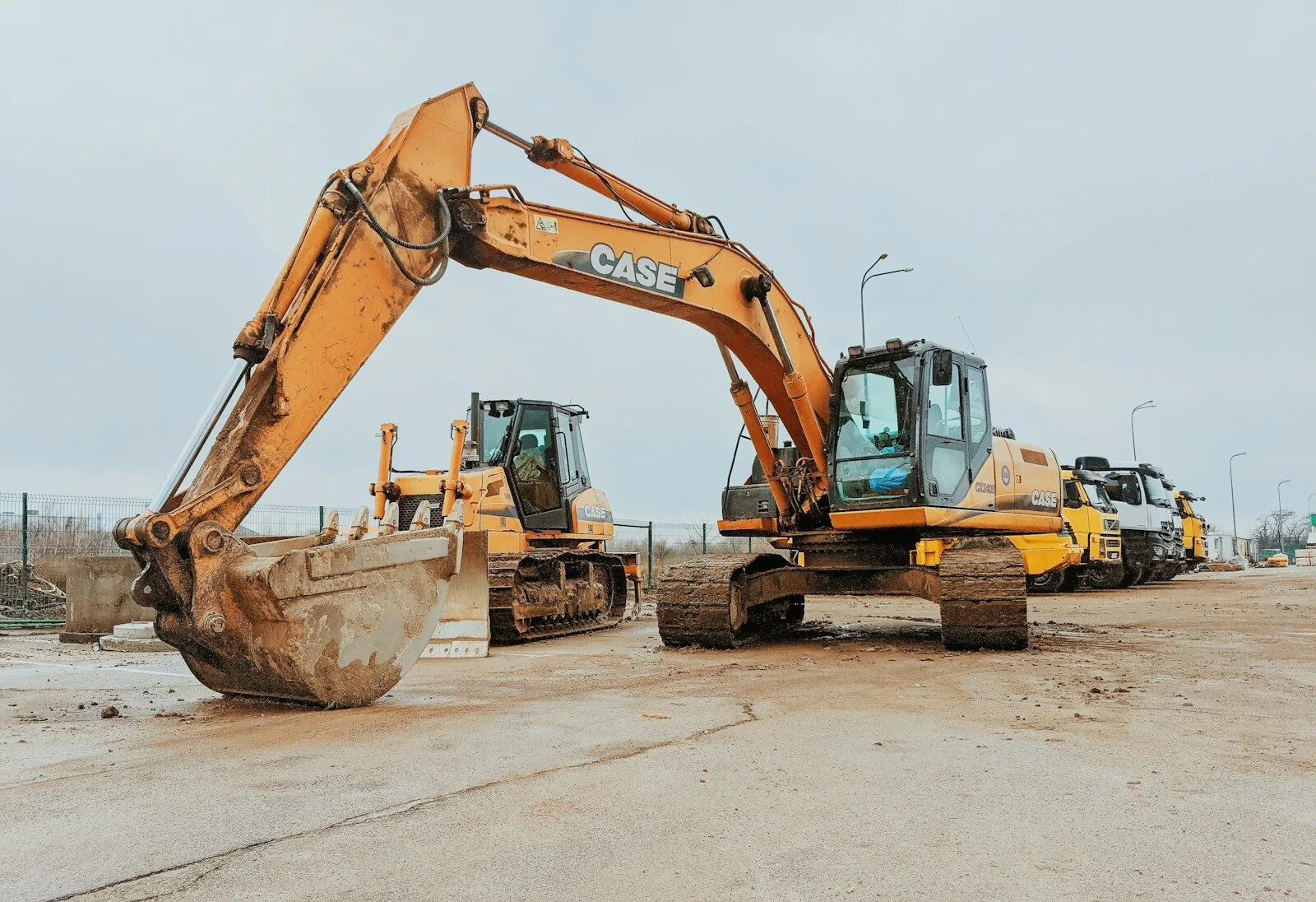 Excavator Rental Abu Dhabi | Chain & Tyre Excavator Hire yellow excavator on gray concrete road during daytime