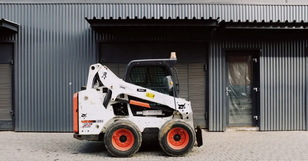 pexels-photo-3964342-3964342 Small white truck loader parked on pavement near black wall of modern building on street in city